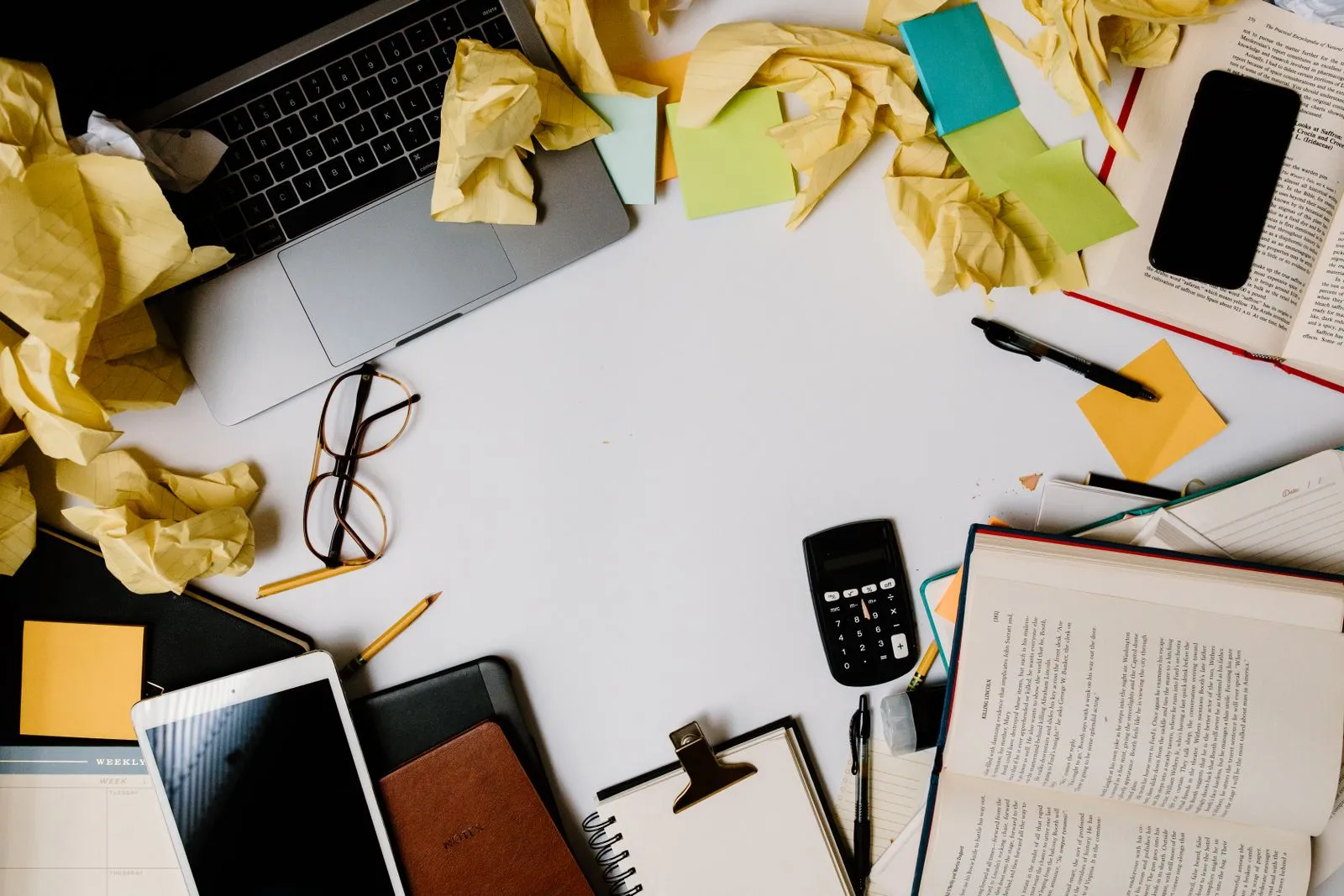 Cluttered, busy workplace desk before professional cleaning